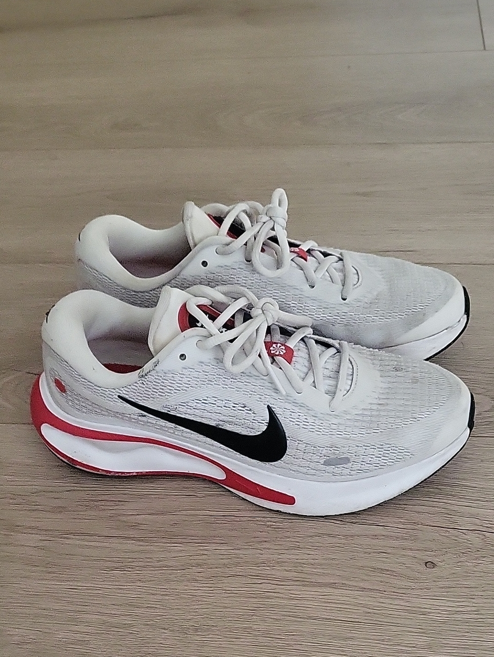 Nike White Sneakers with Black Swoosh and Red Accents